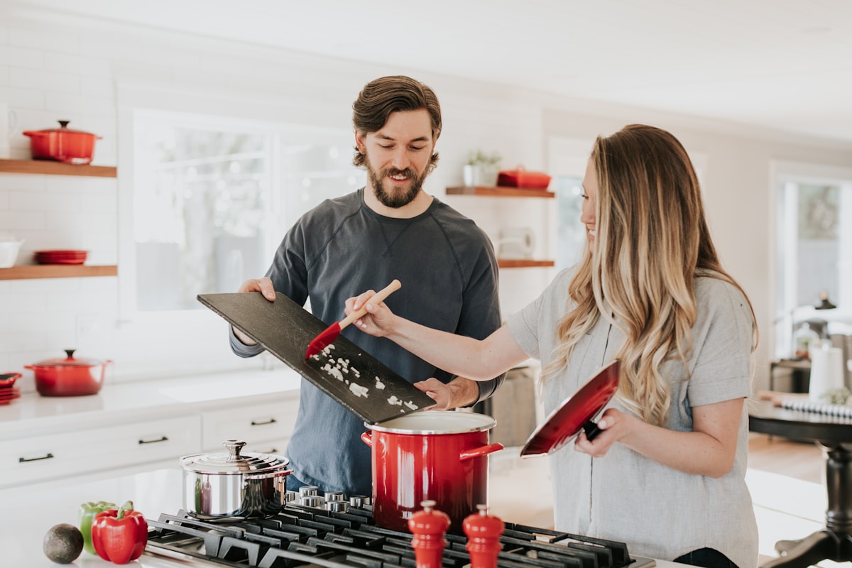 Person learning to cook in a bright kitchen